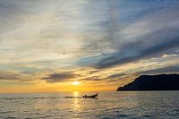 Fisherman heads home during sunset