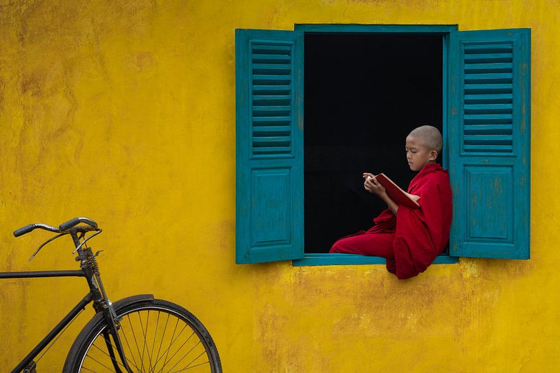 Reading a book in the window frame by Anges van der Logt
