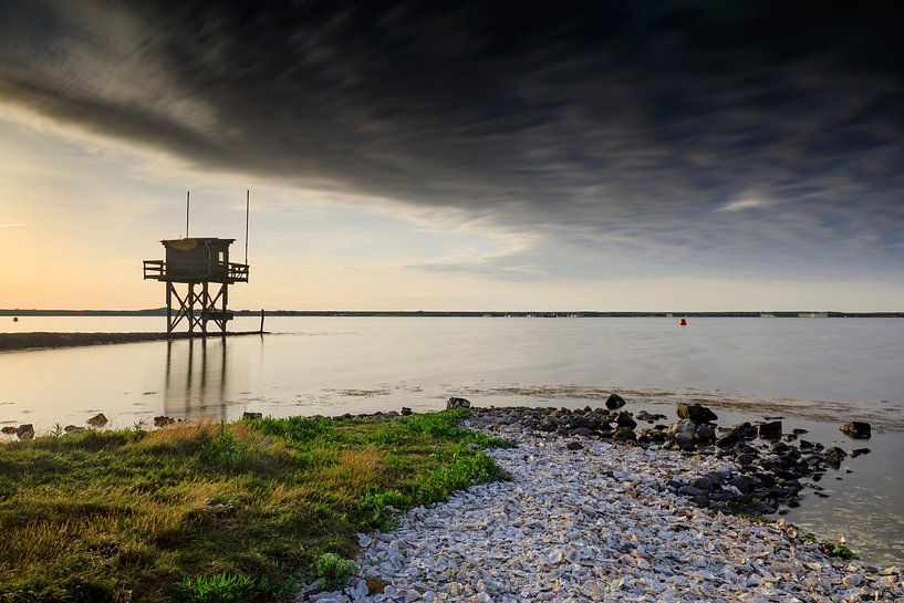 beautiful sunset behind a fisherman's house at the waterfront in Scharendijke in the province of Zee by gaps photography