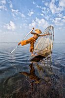 VISSER OP TRADITIONELE MANIER BIJ ZONSOPGANG AAN HET WERK OP HET