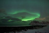 Northern lights as a curtain above Norwegian beach