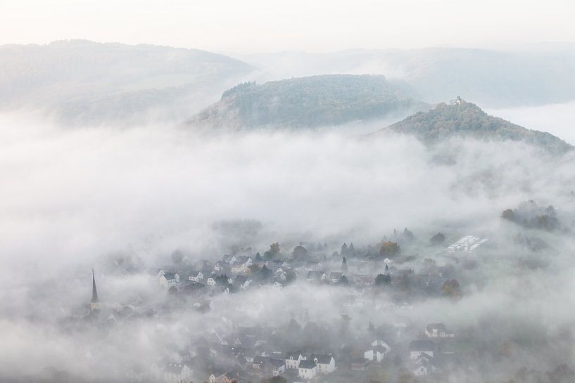 Fog over the valley in the village of Wolf an der Mosel on the Moselle in Germany by Bas Meelker