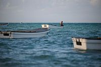 fisherman prepares his boat to set sail