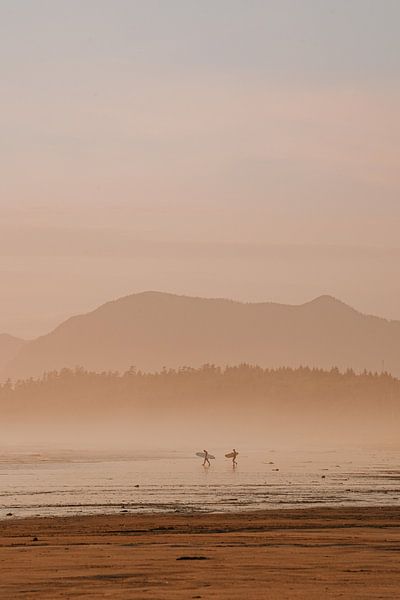 Surfers at sunset on Longbeach, Vancouver Island by Anneloes van Acht