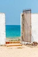 Oude metalen poort naar het strand bij de oceaan in Sri Lanka