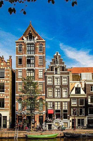 House facades and street boats on a canal canal in Amsterdam Netherlands by Dieter Walther