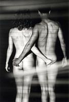 Black and white nude set intimately behind luxaflex