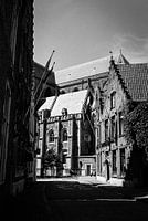 alley with cyclist in Bruges, Belgium