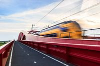 Train speeding across a dutch bridge