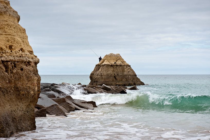 Fisherman on rock by the sea by Remke Spijkers