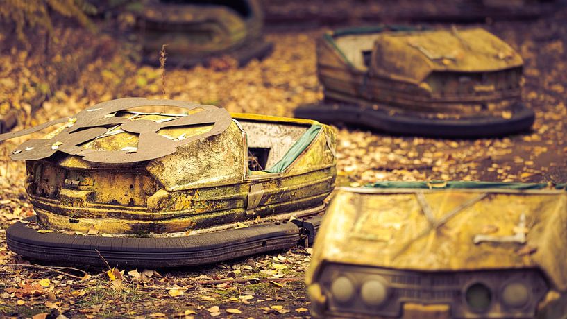 Rusty bumper cars in the amusement park of the ghost town Prypyat near Chernobyl by Robert Ruidl