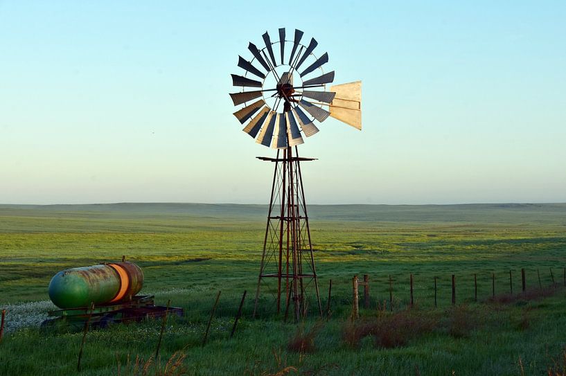 a water pump wind turbine on a green field by Werner Lehmann
