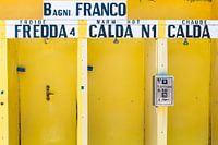 Yellow douche cabins in Italy with hot and cold in Italian