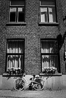 Bicycle on the wall of the house in Bruges