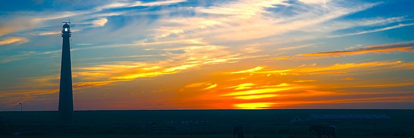 sunset with lighthouse Den Helder by eric van der eijk
