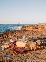 Colourful Ibiza picnic on the beach at sunset