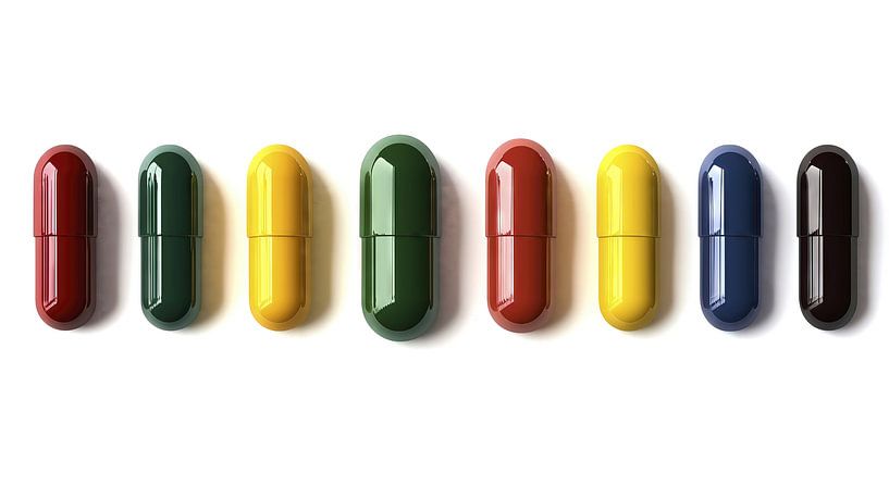 Colourful pills on a white background by Frank Heinz