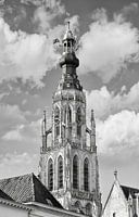 Ornate church tower against cloudy sky