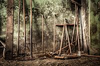 Still life of pitchforks and brooms