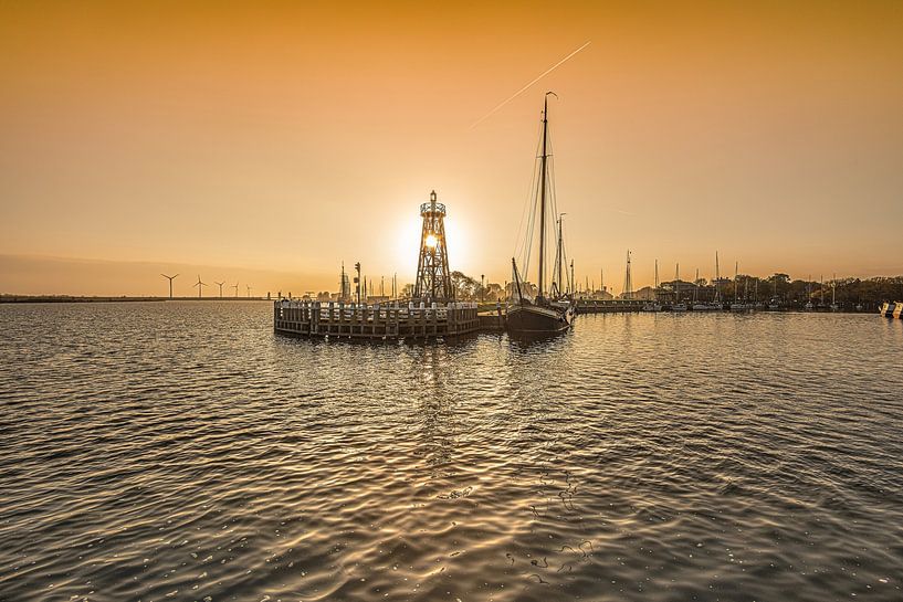 Sunrise at the harbour entrance to the IJsselmeer town of Enkhuizen by Harrie Muis