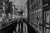 Amsterdam Damrak canal at night in Black and White