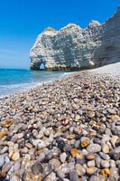 Shiny pebbles and chalk cliff, on the beach near Etretat