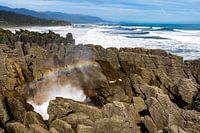 Pancake Rocks blowhole with rainbow, Punakaiki, New Zealand
