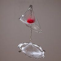 Red drop in glass due to high-speed water drop
