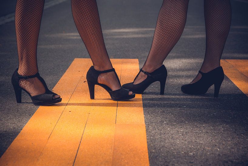 Zwei elegante Frauen mit hochhackigen schwarzen Schuhen und sexy Netzstrümpfen von Denny Gruner