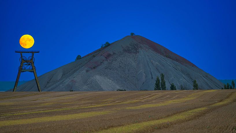 The moon above the winding tower at the spoil tip by Andreas Völkel