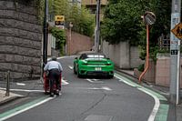 The contrast, Porsche 911 and postman