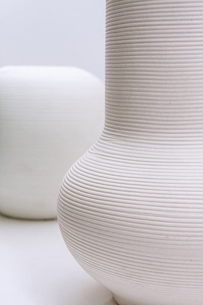 Handcrafted white vases in a white interior by Tony Vingerhoets