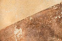 Tuscan colours on a weathered wall in the village of Balazuc France