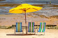 Beach chairs & a parasol on the beach of the Atlantic coast in Bahia, Brazil.