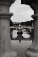 Bridge in rome seen through the pillars of the Ponte Vittorio Emanuele II