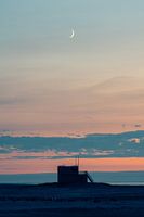 Waxing Moon over a lifeguard tower and the North Sea