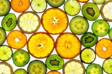Collage of slices of fruit and vegetables with a white background. by Carola Schellekens