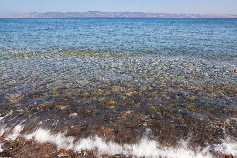 Seawater undulates over pebbles in the Aegean Sea by Frans Rombout