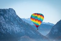 Hot air balloons adorn the sky over a snowy Inzell in Germany