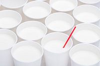 White cups with one red straw