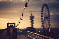 Suspended lamps on a pier during sunset