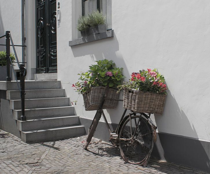Old bike with flowers in a dutch city. by Birgitte Bergman
