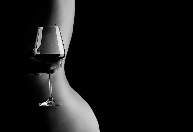 Artistic nude photo woman with glass of wine behind her back by Retinas images
