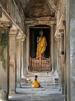 Vrouw bidt tot Boeddha in Angkor Wat, Cambodja