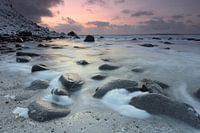 Snow between the rocks on a beach