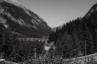Red train over bridge in the mountains, Switzerland