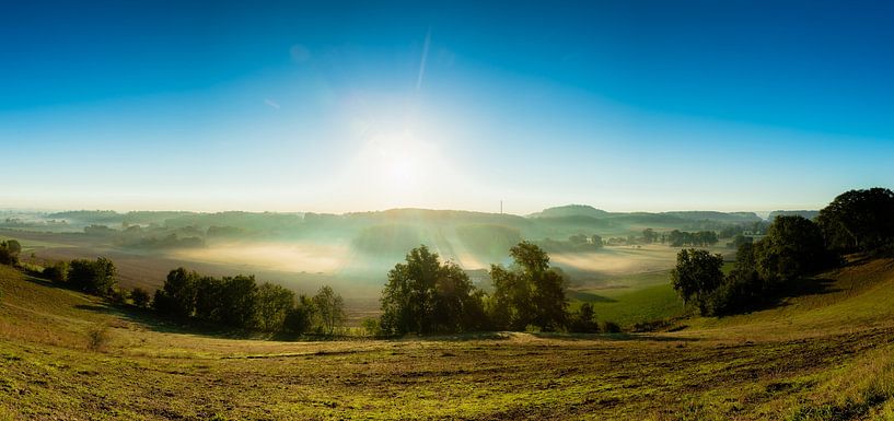 autumn morning panorama of the Jeker valley with mist and sun harps by Kim Willems