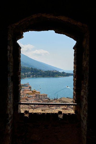 View through a window of Scaliger Castle over Malcesine in Italy by Heiko Kueverling