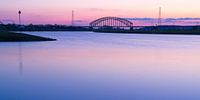 Brug over rivier tegen roze lucht
