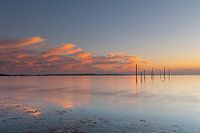 Sunset with poles like a mirror